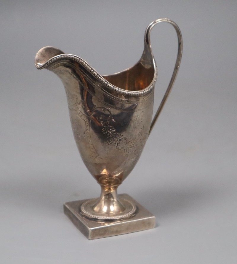 A George III engraved silver helmet shaped cream jug, Peter & Ann Bateman, London, 1793, 14.3cm, 3.5 oz.